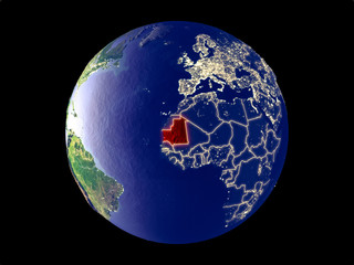 Mauritania from space on model of planet Earth with city lights. Very fine detail of the plastic planet surface and cities.