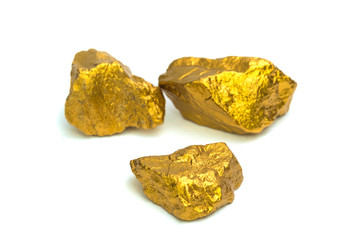 A pile of gold nuggets or gold ore on white background, precious stone or lump of golden stone, financial and business concept.