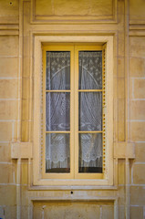 Windo with vintage lace curtains