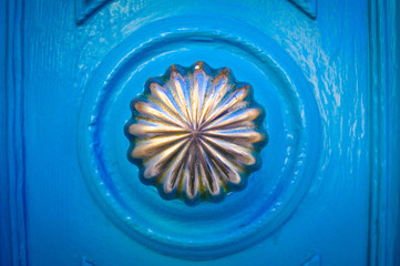 Blue door with decorated knob