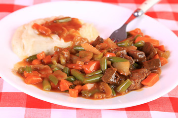 Pot Roast Dinner on White Plate and Checkered Tablecloth