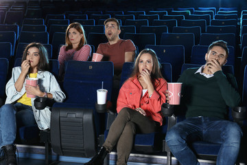 Naklejka premium Young people watching movie in cinema theatre