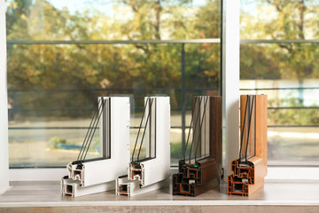 Samples of modern window profiles on sill indoors. Installation service