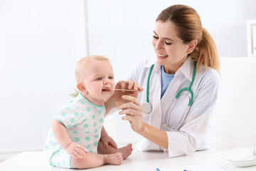 Children's doctor examining baby's throat in hospital