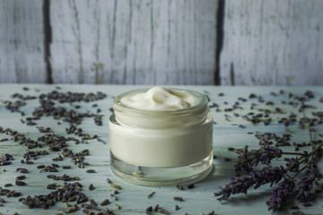 Fototapeta na wymiar Homemade lavender facial cream on a light wooden background