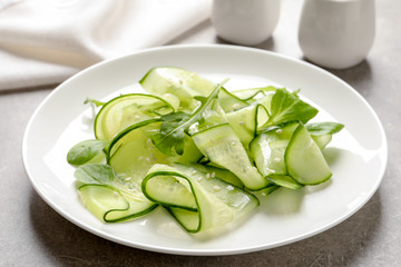 Plate with delicious cucumber salad on table, closeup