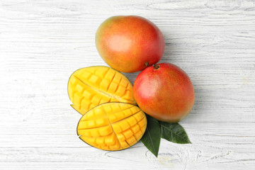 Flat lay composition with mango on white wooden background