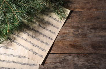 Composition with music sheets and space for text on wooden background, top view