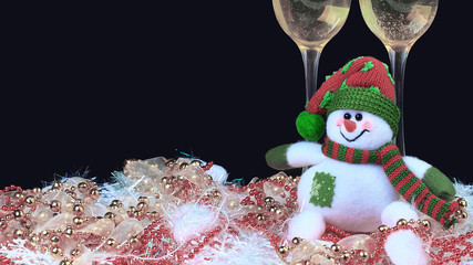 Glasses of champagne with snowmen, decorated, black background