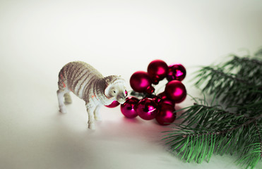 toy lamb with Christmas balls and fir legs. Christmas decoration