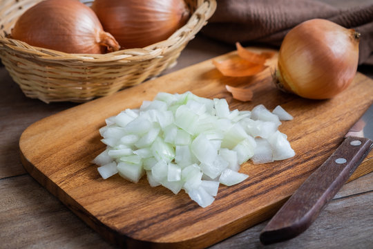 Fresh chopped onions on wooden cutting board