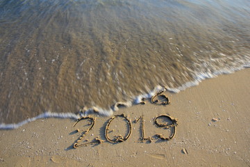 2019 write on sand the beach.Happy new year concept.