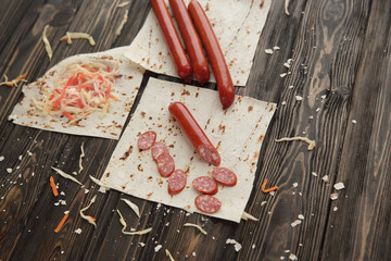 ingredients for making burritos, isolated on dark wooden backgro
