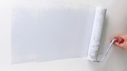 closeup.businessman drawing a paint roller on the wall.