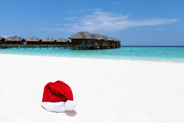 Fototapeta na wymiar Santa hat on chair with water lodges on background
