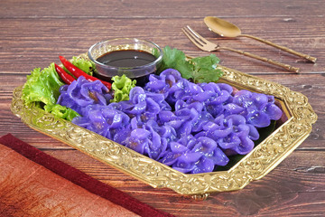 Royal Thai cuisine : Purple blue color Flower-shaped Thai dumpling (Khanom Chor Muang) Famous...