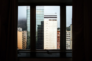 Buildings in the neighborhood of Copacabana (Rio de Janeiro) seen through a window with raindrops