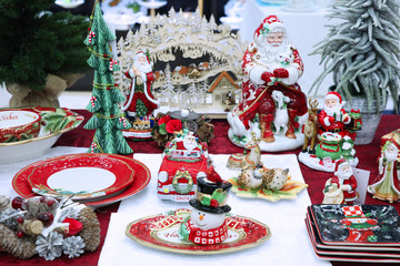 Colorful Christmas Souvenirs, statues of Santa Claus, snowman, plates with symbols of the New year