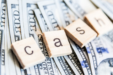 one hundred dollars bill and word cash closeup