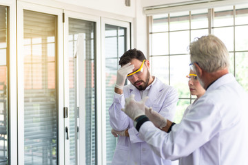 Group of scientist explaining research information together in the laboratary
