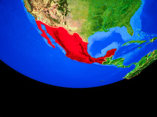 Mexico from space on model of planet Earth with country borders.