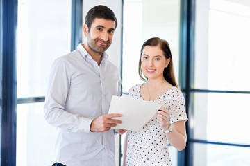 Image of two young business people in office