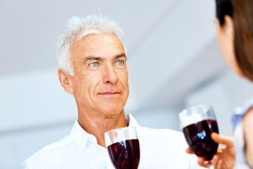 Portrait of a couple having a glass of red wine