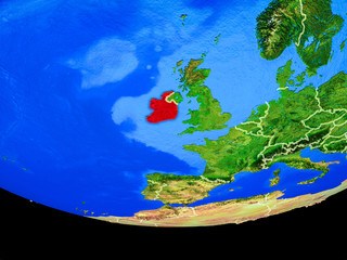 Ireland from space on model of planet Earth with country borders.