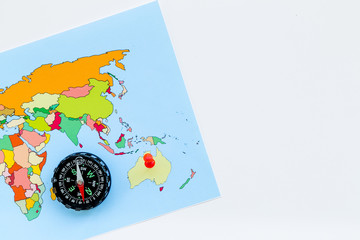 travel direction and trip planning concept with compass and map of the world on white background top view mock up