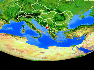 Montenegro from space on model of planet Earth with country borders.