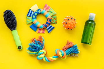 Grooming and training equipment for pets care yellow background top view