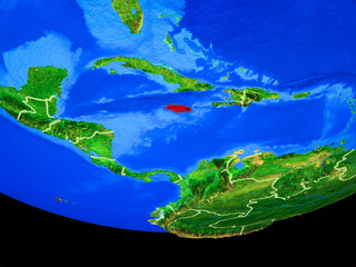 Jamaica from space on model of planet Earth with country borders.