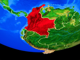 Colombia from space on model of planet Earth with country borders.