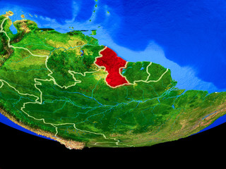 Guyana from space on model of planet Earth with country borders.