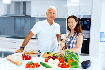 Mature couple cooking at home