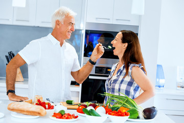 Mature couple cooking at home