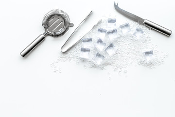 pile of ice cubes and bar equipment on white bar table top view mock-up