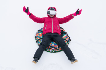 Fototapeta na wymiar girl with glasses virtual reality, sitting on the cheesecake, on the background of white snow