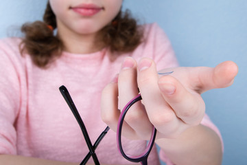 close - up, the girl is holding a set of items to improve vision
