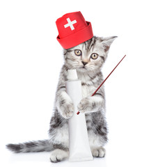 Cute kitten in medical cap with a tube of toothpaste and pointing stick. isolated on white background