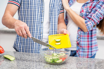 Close up young couple cooking together at home