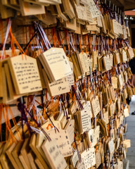 Wooden plaques with wishes and prayers at Japanese Shinto shrine.