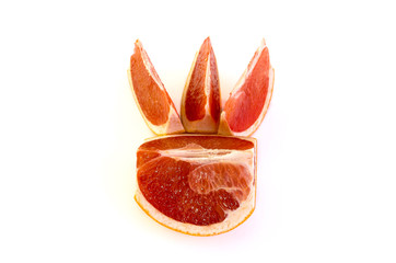 Fresh whole and sliced grapefruit on white background.