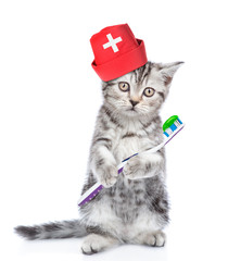 Cute kitten in medical cap with a toothbrush. isolated on white background
