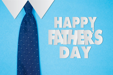 Happy Father's Day text with  tie on blue paper shirts background
