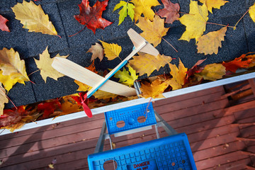 Toy airplane lost in a gutter on a roof
