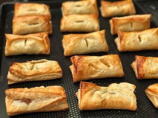 Homemade Puff pastry with pineapple jam, chicken curry , purple potato on black bake tray. Bakery for party , Delicious and unhealthy