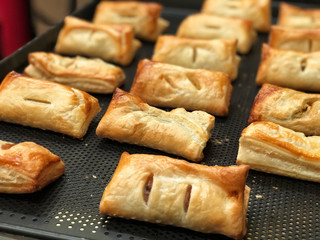 Homemade Puff pastry with pineapple jam, chicken curry , purple potato on black bake tray. Bakery for party , Delicious and unhealthy