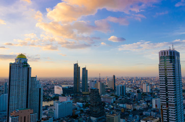 Fototapeta na wymiar Evening scene in a aerial view of Bangkok buildings, which Bangkok city downtown with sunset sky mood