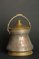 ancient metal bowl on dark background. antique bronze tableware
